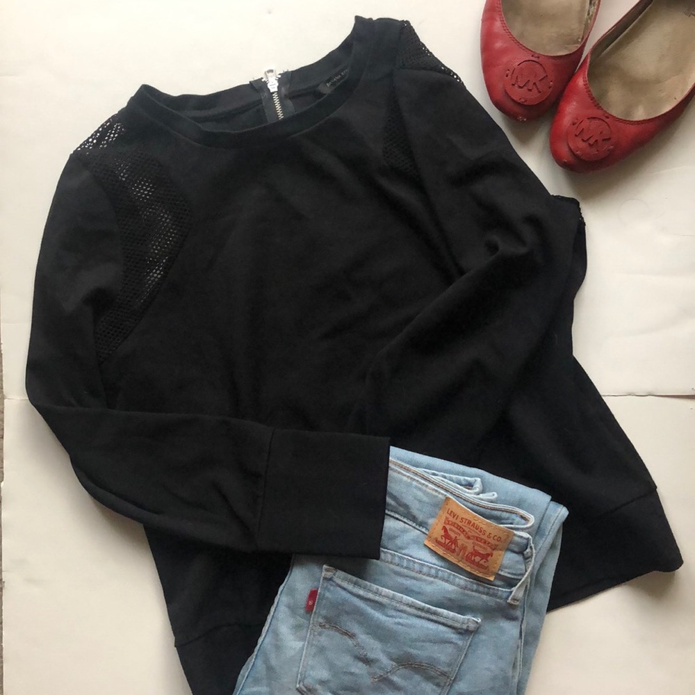 Black sweater with mesh detail.
